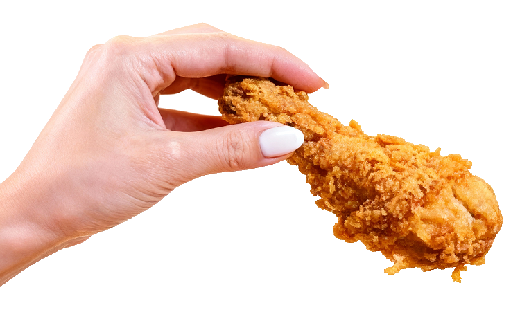 Hand holding a piece of fried chicken